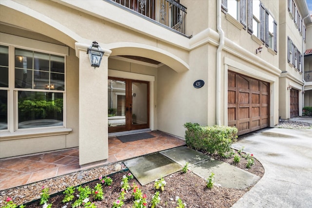 431 Jackson Hill St, Houston, TX 77007 - entrance to property with french doors, an attached garage, and stucco siding