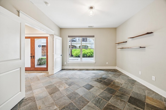 431 Jackson Hill St, Houston, TX 77007 - empty room featuring stone tile flooring and a smoke detector