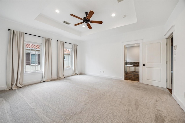 431 Jackson Hill St, Houston, TX 77007 - unfurnished bedroom featuring light carpet, a tray ceiling, recessed lighting, ensuite bath, and a ceiling fan