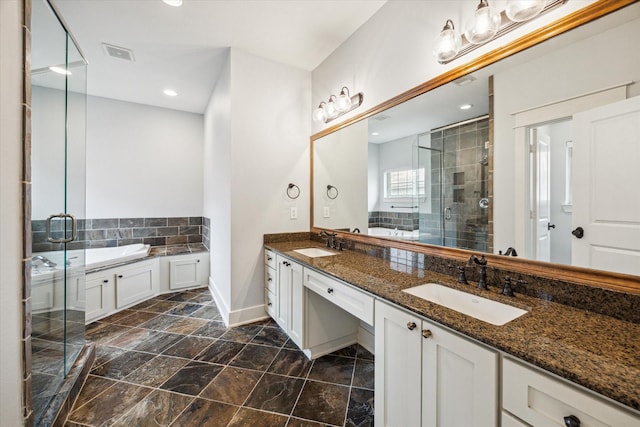 431 Jackson Hill St, Houston, TX 77007 - full bathroom with a bath, double vanity, a shower stall, stone finish flooring, and recessed lighting