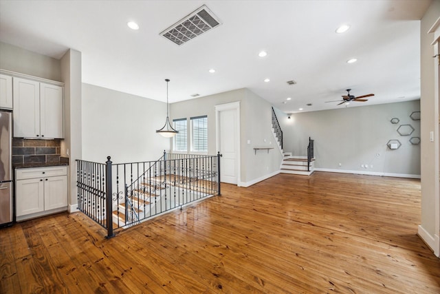 431 Jackson Hill St, Houston, TX 77007 - hallway with an upstairs landing, light wood-style flooring, and recessed lighting