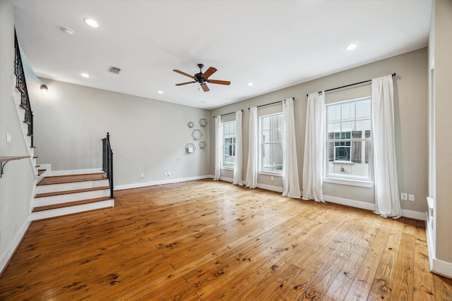 431 Jackson Hill St, Houston, TX 77007 - unfurnished living room featuring ceiling fan, light wood finished floors, recessed lighting, and stairway
