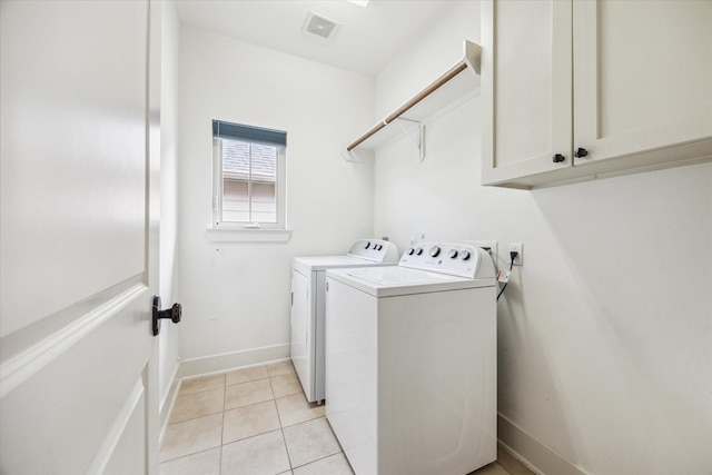 431 Jackson Hill St, Houston, TX 77007 - washroom with separate washer and dryer, cabinet space, and light tile patterned flooring