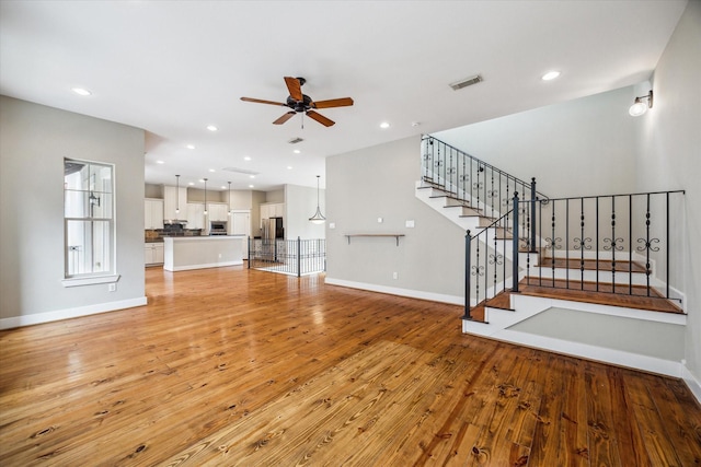 431 Jackson Hill St, Houston, TX 77007 - unfurnished living room featuring a ceiling fan, light wood-style flooring, stairs, and recessed lighting