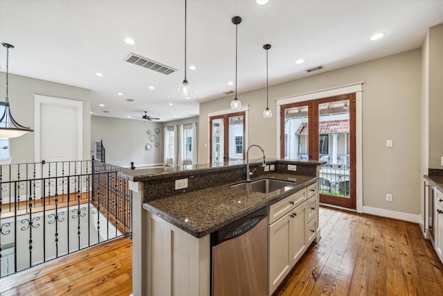 431 Jackson Hill St, Houston, TX 77007 - kitchen featuring stainless steel dishwasher, light wood-style floors, recessed lighting, ceiling fan, and a kitchen island with sink