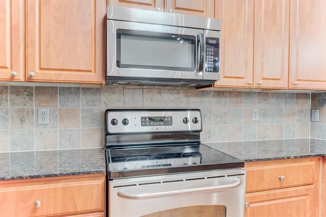 1711 Old Spanish Trl Unit 110, Houston, TX 77054 - kitchen with stainless steel appliances, decorative backsplash, and dark stone counters