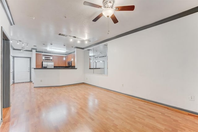1711 Old Spanish Trl Unit 110, Houston, TX 77054 - unfurnished living room with track lighting, crown molding, ceiling fan, and light wood-style floors