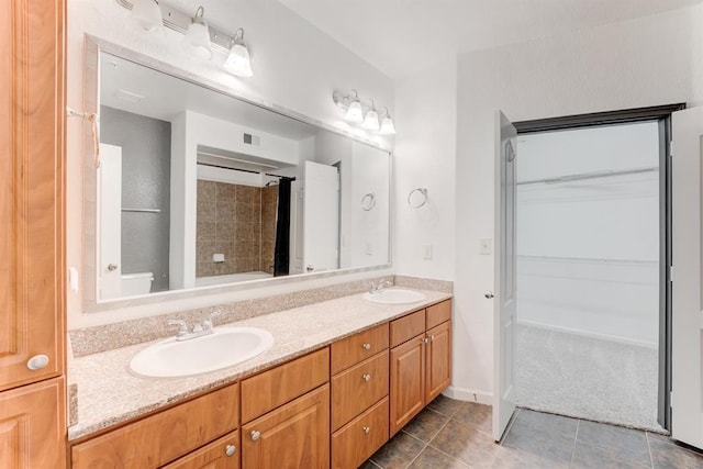 1711 Old Spanish Trl Unit 110, Houston, TX 77054 - full bath with double vanity, tile patterned floors, and a walk in closet