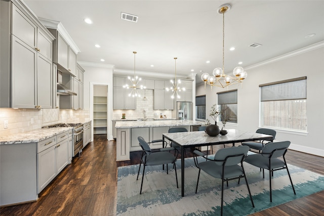 7706 Janak Dr Unit C, Houston, TX 77055 - dining room featuring a chandelier, recessed lighting, ornamental molding, and dark wood-type flooring