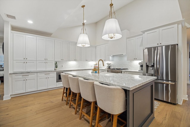 2022 Chaparral Dr, Houston, TX 77043 - kitchen featuring stainless steel refrigerator with ice dispenser, high vaulted ceiling, light wood-type flooring, backsplash, and white cabinetry
