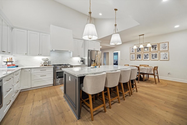 2022 Chaparral Dr, Houston, TX 77043 - kitchen with stainless steel appliances, high vaulted ceiling, recessed lighting, tasteful backsplash, and a breakfast bar area