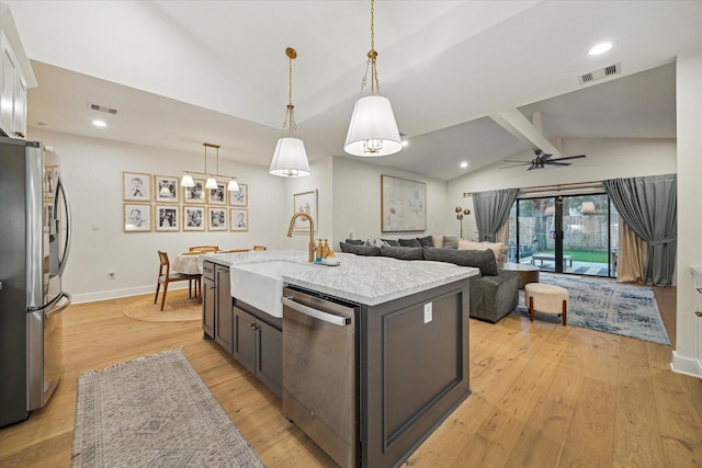 2022 Chaparral Dr, Houston, TX 77043 - kitchen featuring stainless steel appliances, light wood-style flooring, ceiling fan, light stone counters, and hanging light fixtures