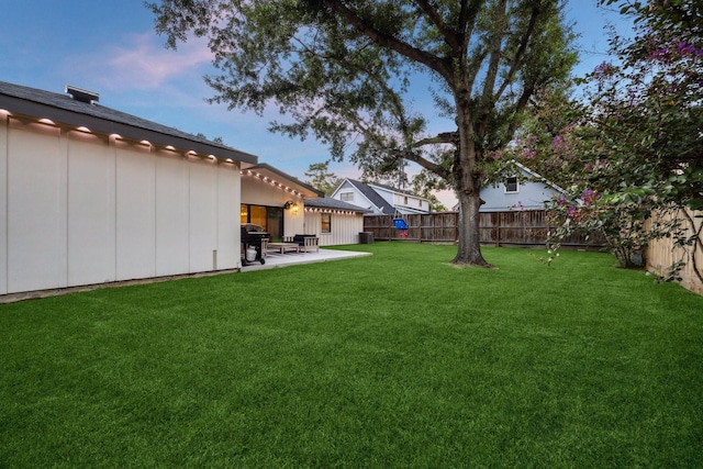 2022 Chaparral Dr, Houston, TX 77043 - yard at dusk featuring a fenced backyard and a patio