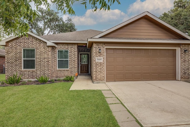 2440 Olympia Dr, West Columbia, TX 77486 - ranch-style house with brick siding, a front yard, a garage, concrete driveway, and roof with shingles