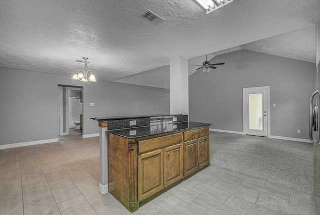 2440 Olympia Dr, West Columbia, TX 77486 - kitchen with open floor plan, brown cabinetry, a textured ceiling, a chandelier, and vaulted ceiling