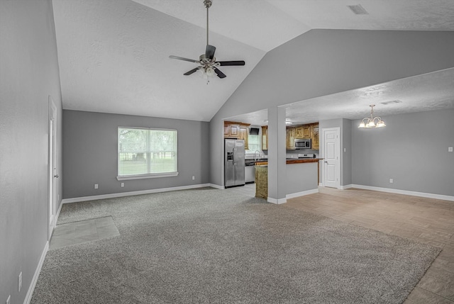 2440 Olympia Dr, West Columbia, TX 77486 - unfurnished living room with a chandelier, ceiling fan, light colored carpet, and high vaulted ceiling