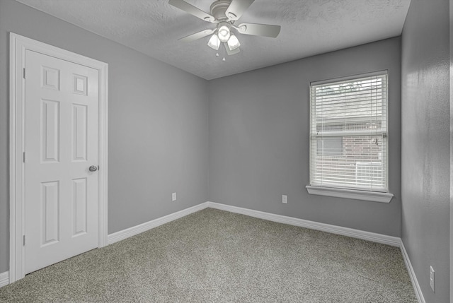 2440 Olympia Dr, West Columbia, TX 77486 - spare room with carpet, a textured ceiling, and a ceiling fan