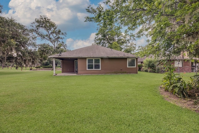 2440 Olympia Dr, West Columbia, TX 77486 - back of house featuring a patio area, a yard, and a shingled roof