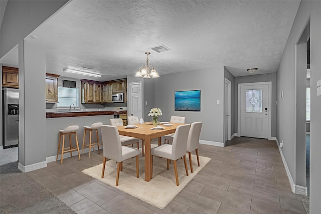 2440 Olympia Dr, West Columbia, TX 77486 - dining room featuring a chandelier and a textured ceiling