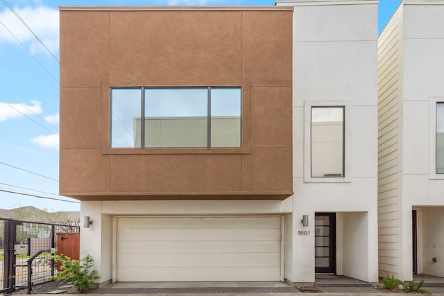 1801 Radcliffe St, Houston, TX 77007 - view of front facade with a garage, a gate, and stucco siding