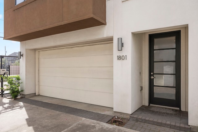 1801 Radcliffe St, Houston, TX 77007 - doorway to property with stucco siding and an attached garage