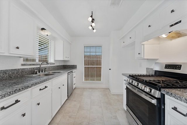 21507 Glenbranch Dr, Spring, TX 77388 - kitchen with stainless steel appliances, dark countertops, plenty of natural light, and white cabinets