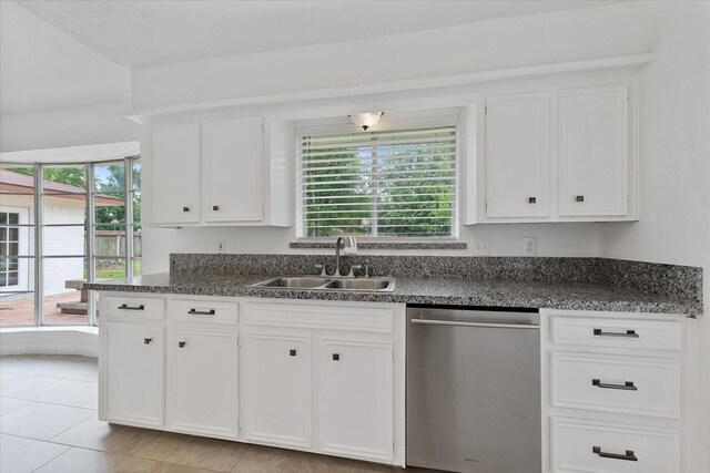 21507 Glenbranch Dr, Spring, TX 77388 - kitchen with stainless steel dishwasher, white cabinets, dark countertops, and light tile patterned floors