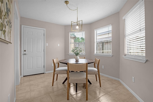 16606 Neumann Dr, Houston, TX 77058 - dining space with a textured ceiling and light tile patterned flooring