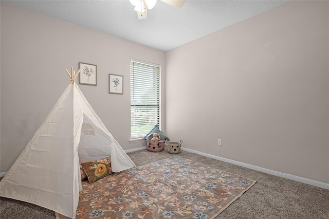 16606 Neumann Dr, Houston, TX 77058 - rec room with carpet flooring, a ceiling fan, and a textured ceiling
