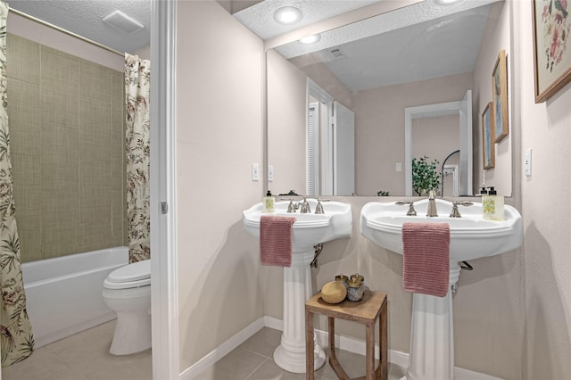 16606 Neumann Dr, Houston, TX 77058 - bathroom featuring tile patterned floors, shower / bath combination with curtain, and a textured ceiling