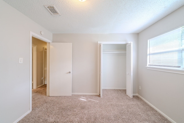 463 Dover Ln, Spring, TX 77373 - unfurnished bedroom featuring carpet, a closet, and a textured ceiling