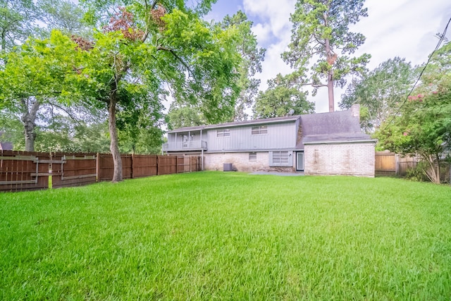 463 Dover Ln, Spring, TX 77373 - rear view of house featuring brick siding and a fenced backyard