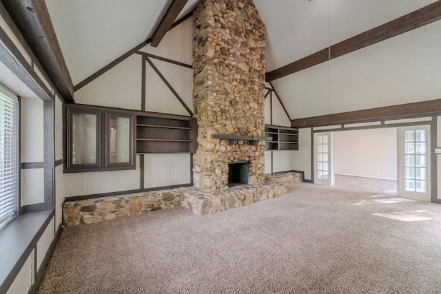 463 Dover Ln, Spring, TX 77373 - unfurnished living room featuring carpet flooring, high vaulted ceiling, beamed ceiling, plenty of natural light, and a stone fireplace