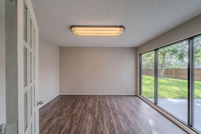 463 Dover Ln, Spring, TX 77373 - unfurnished room with dark wood-type flooring and a textured ceiling