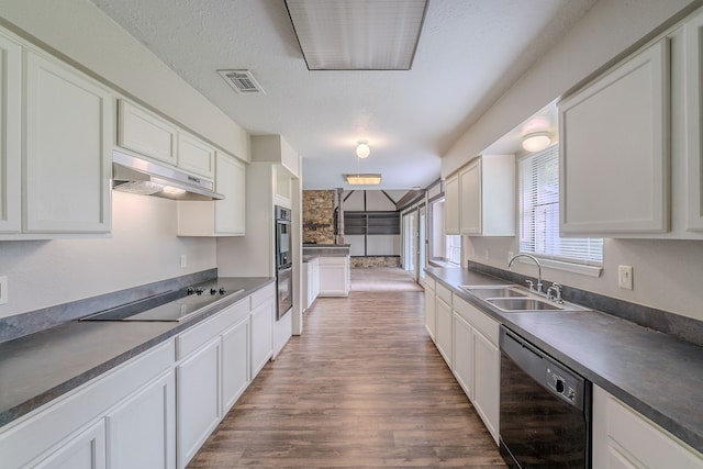 463 Dover Ln, Spring, TX 77373 - kitchen featuring black appliances, under cabinet range hood, and white cabinetry