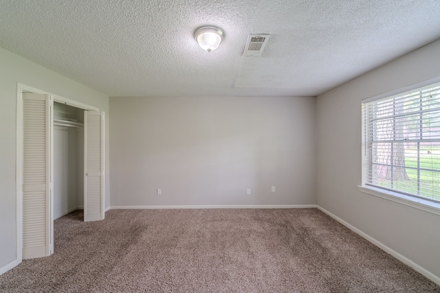 463 Dover Ln, Spring, TX 77373 - unfurnished bedroom with carpet floors, a textured ceiling, and a closet