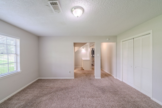 463 Dover Ln, Spring, TX 77373 - unfurnished bedroom featuring carpet flooring, a closet, and a textured ceiling