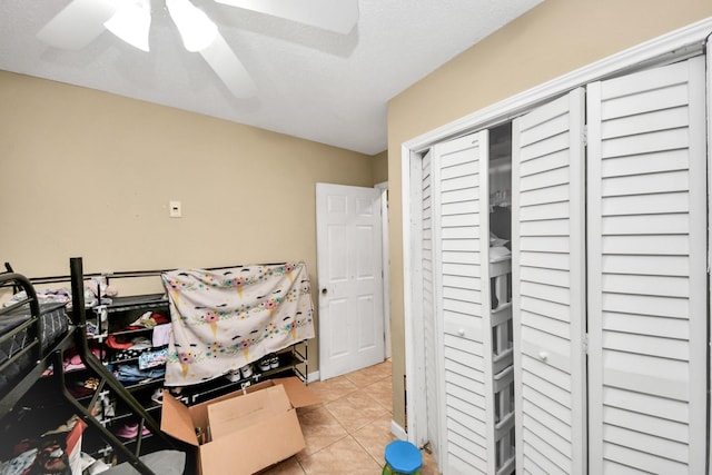 4827 Dalmatian Dr, Houston, TX 77045 - bedroom with tile patterned flooring, ceiling fan, and a closet