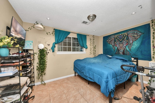 4827 Dalmatian Dr, Houston, TX 77045 - tiled bedroom with a textured ceiling and baseboards