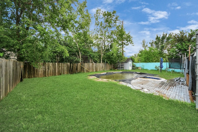 4827 Dalmatian Dr, Houston, TX 77045 - fenced backyard featuring a trampoline and a storage unit