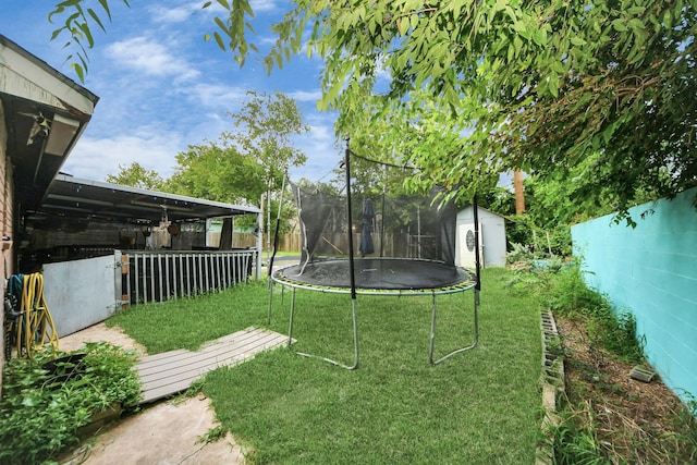 4827 Dalmatian Dr, Houston, TX 77045 - view of yard featuring a trampoline and a storage unit