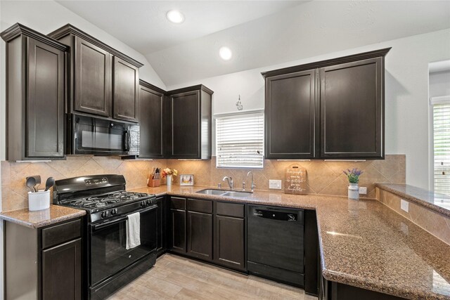 13215 Dover Bluff Dr, Rosharon, TX 77583 - kitchen with black appliances, lofted ceiling, light stone counters, light wood finished floors, and tasteful backsplash