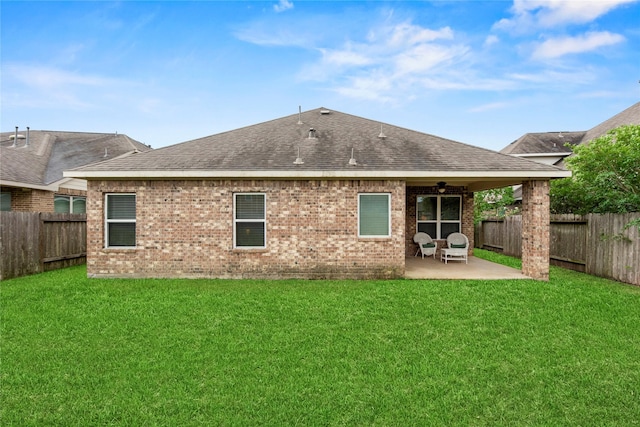 13215 Dover Bluff Dr, Rosharon, TX 77583 - rear view of property featuring roof with shingles, a patio area, a fenced backyard, and brick siding