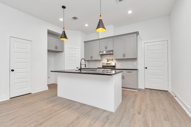 2213 Lee St, Houston, TX 77026 - kitchen featuring gray cabinets, dark countertops, stainless steel range with electric cooktop, under cabinet range hood, and recessed lighting