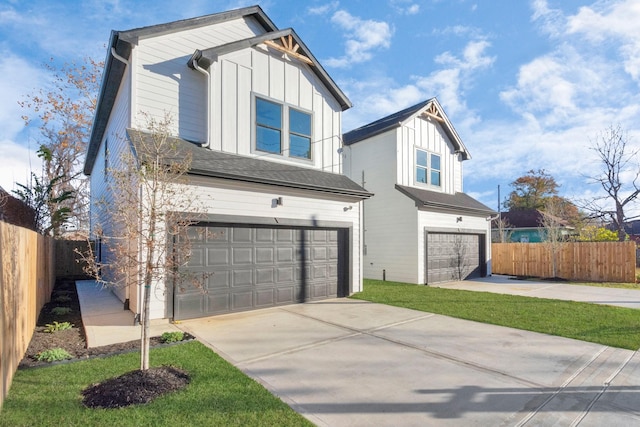 2213 Lee St, Houston, TX 77026 - view of front of home with an attached garage, board and batten siding, and driveway