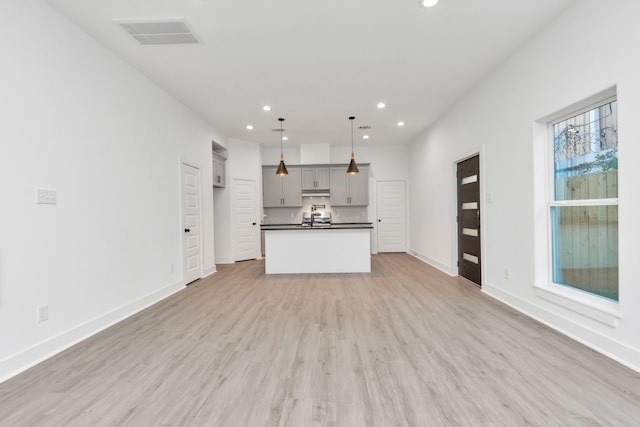 2213 Lee St, Houston, TX 77026 - unfurnished living room featuring recessed lighting and light wood-style floors