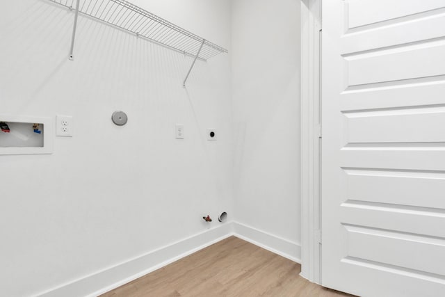 2213 Lee St, Houston, TX 77026 - washroom with hookup for a gas dryer, electric dryer hookup, light wood finished floors, and washer hookup