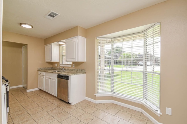 1011 Minnesota St, South Houston, TX 77587 - kitchen featuring stainless steel appliances, white cabinets, plenty of natural light, and light tile patterned flooring