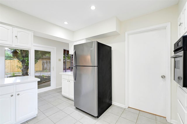 9306 Claridge Dr, Houston, TX 77031 - kitchen featuring stainless steel appliances, light tile patterned floors, white cabinetry, light countertops, and recessed lighting