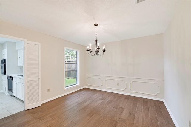 9306 Claridge Dr, Houston, TX 77031 - empty room featuring a chandelier and wood finished floors